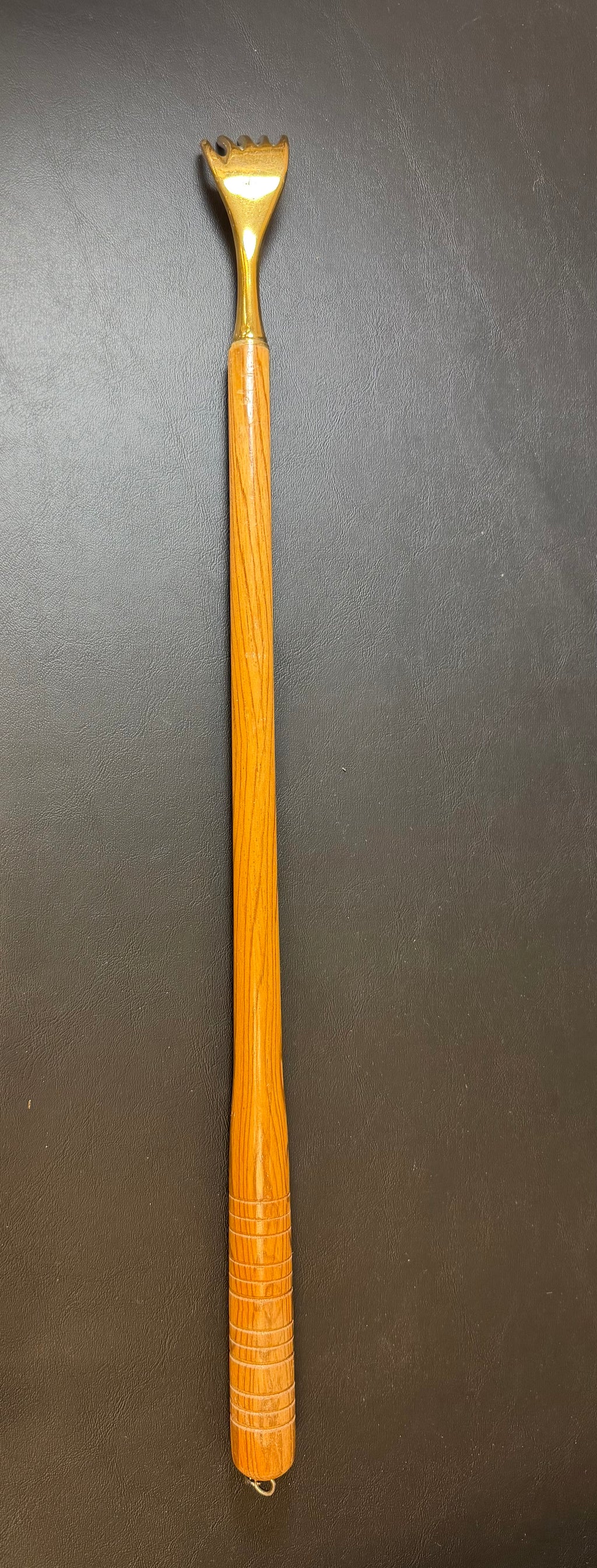 Brass back scratcher with wooded handle