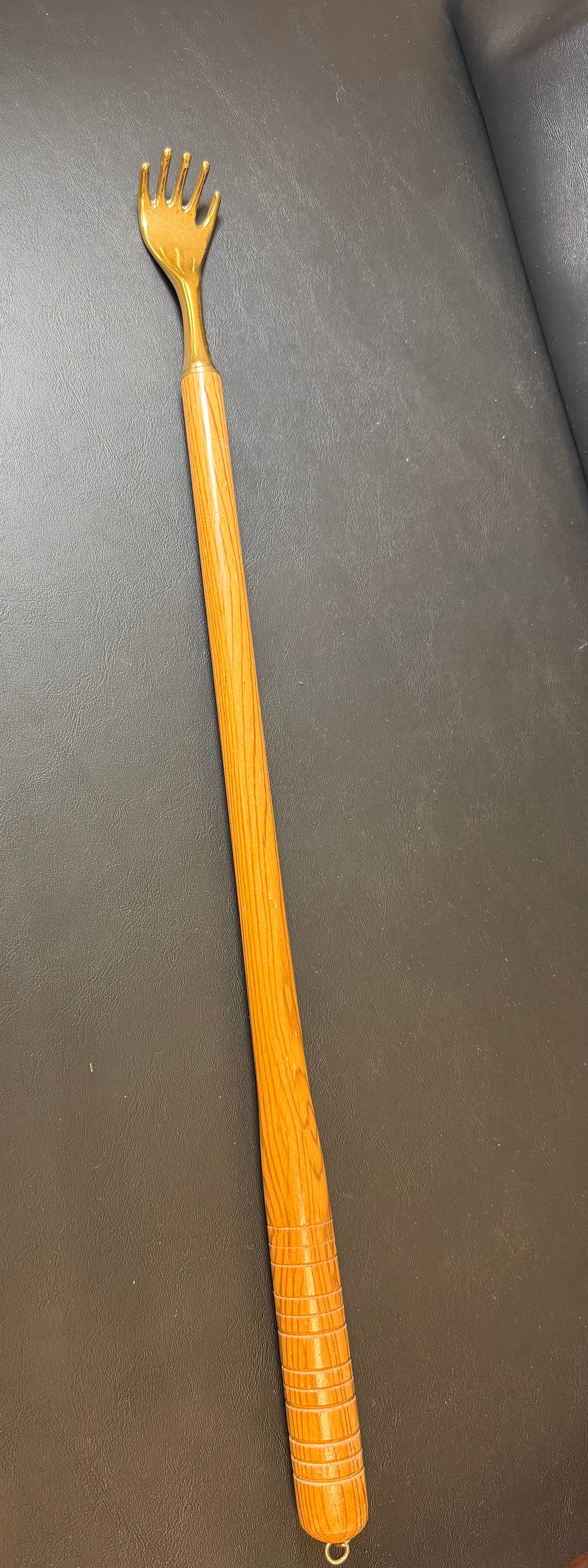 Brass back scratcher with wooded handle